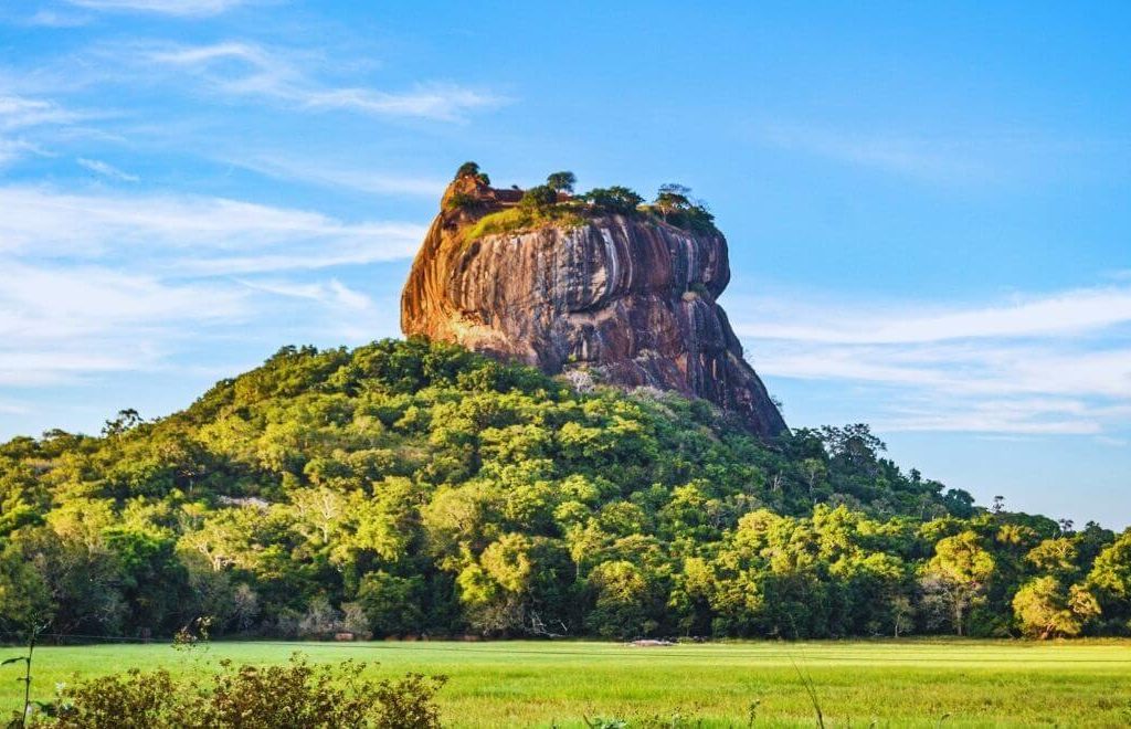Sigiriya Rock Fortress rising above green forest in Sri Lanka