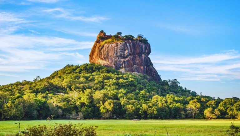 Sigiriya Rock Fortress rising above green forest in Sri Lanka