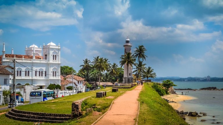Galle Lighthouse and palm trees inside Galle Fort
